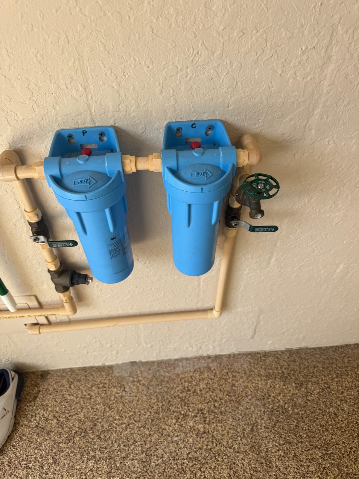Whole-home water filters checked during a home watch visit
